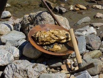 gold-in-pan-by-river